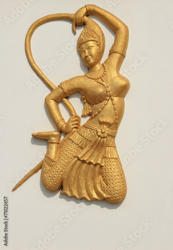 deva statue on the white wall