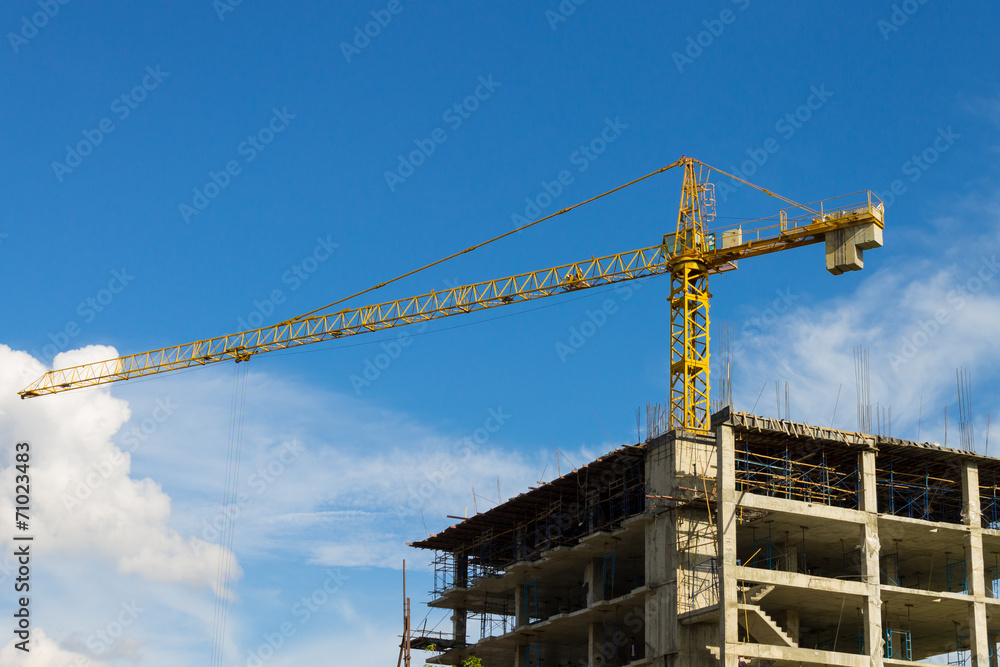 Tower Crane Wide Screen and Skyscraper on Blue Sky Background Tower Crane Wide Screen and Skyscraper on Blue Sky Background