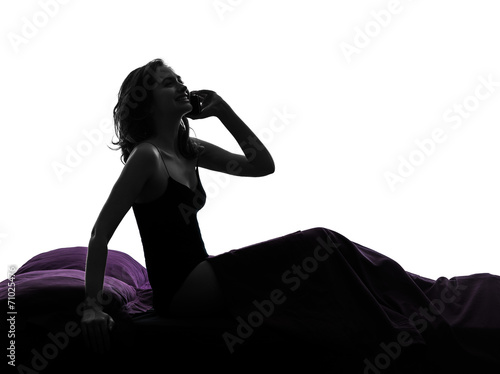  woman happy on the telephone in bed silhouette