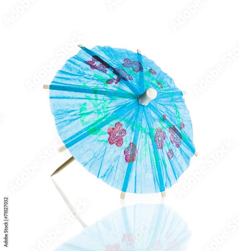 blue cocktail umbrella isolated against white background