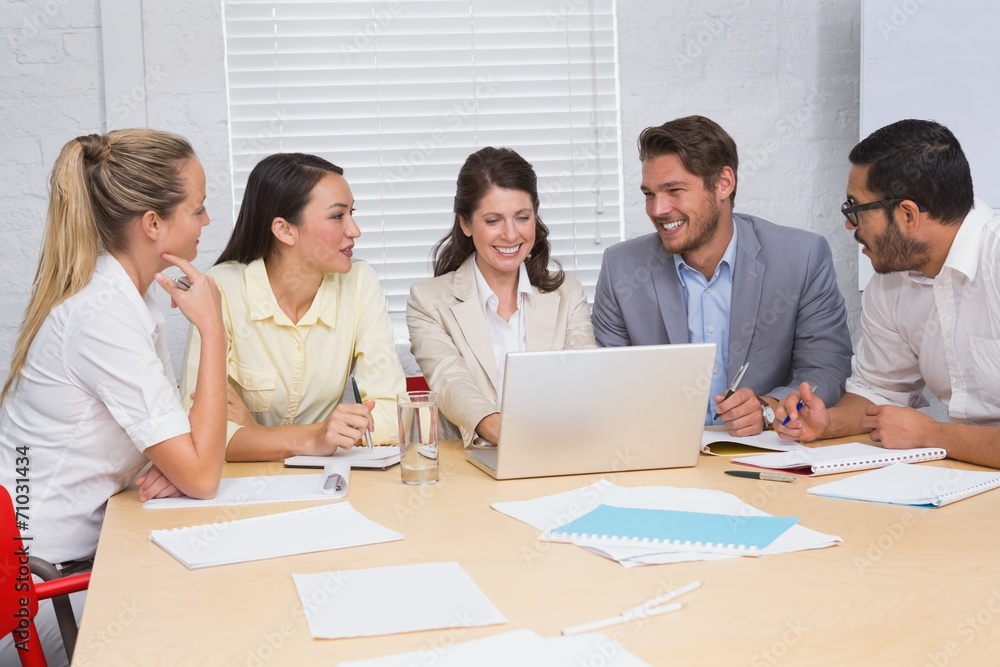Casual business team having a meeting using laptop Casual business team having a meeting using laptop