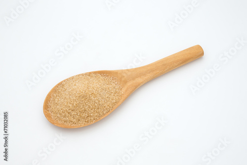 Brown sugar in a wooden spoon