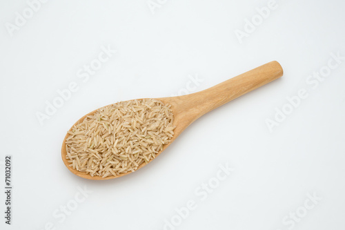 Brown rice in a wooden spoon