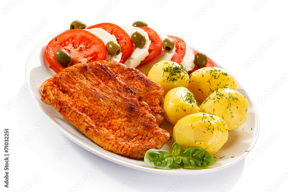Fried pork chops, boiled potatoes and caprese salad Fried pork chops, boiled potatoes and caprese salad