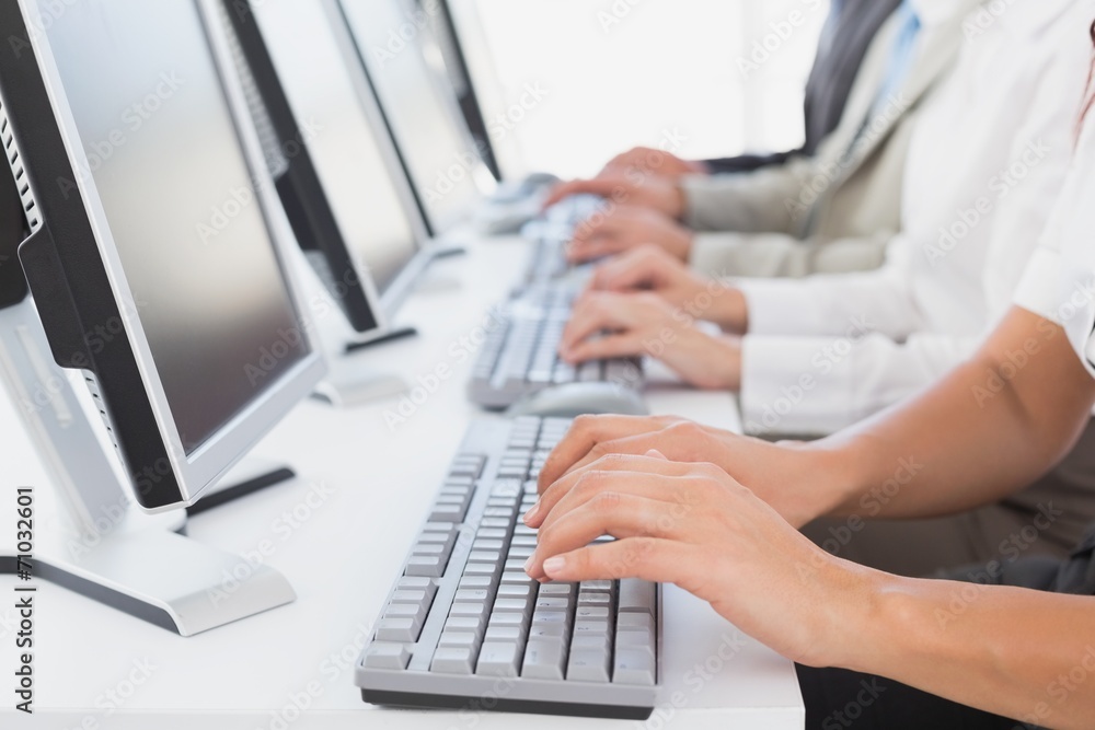 Employees typing on their computers Employees typing on their computers