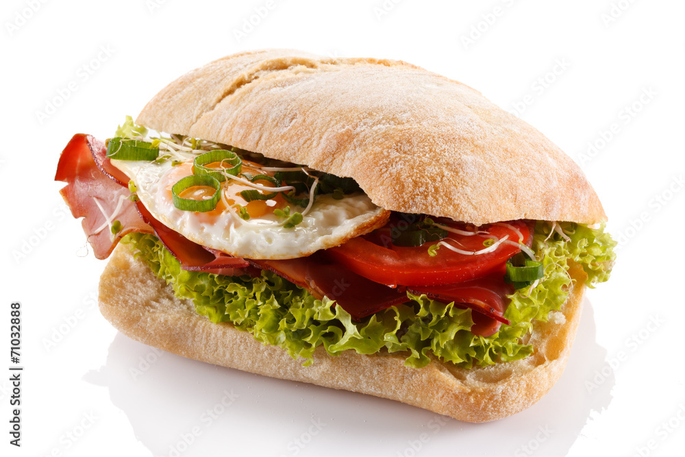 Breakfast - breadroll, fried egg, bacon and vegetables Breakfast - breadroll, fried egg, bacon and vegetables