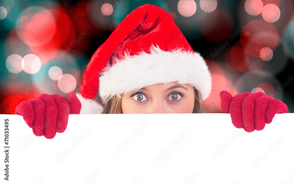 Composite image of festive blonde holding a poster Composite image of festive blonde holding a poster