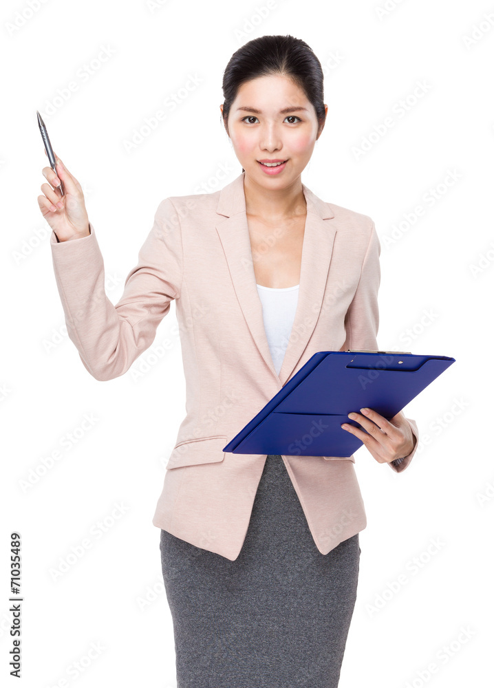 Businesswoman with clipboard and pen point up