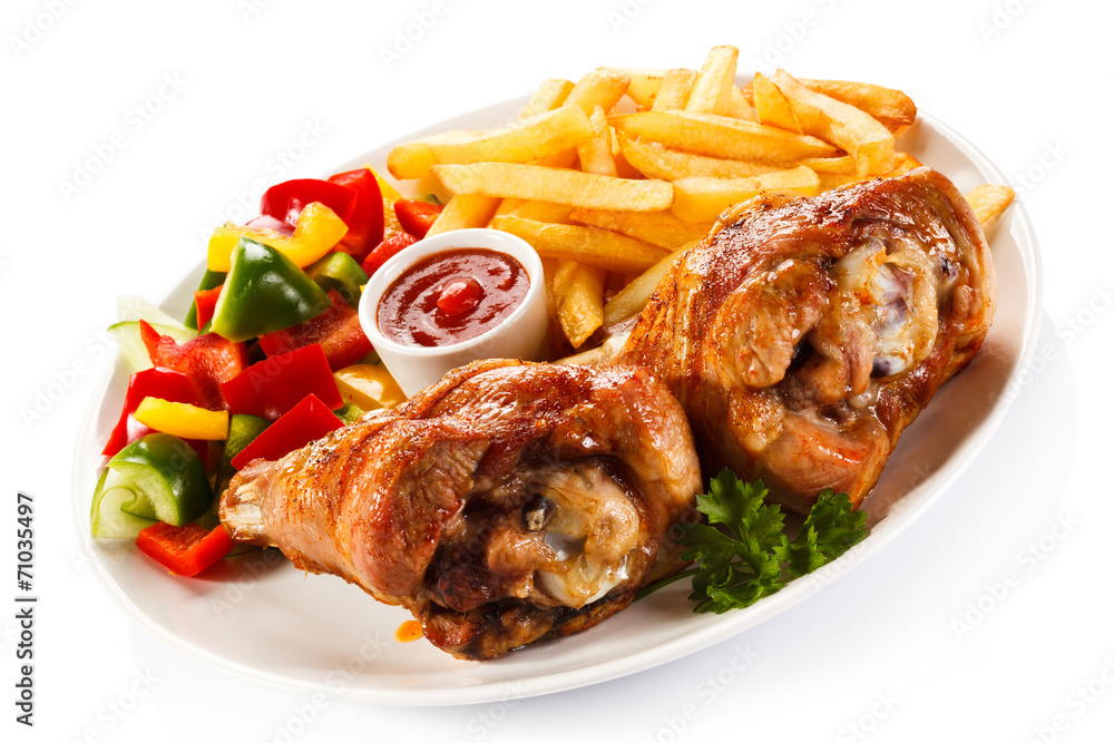 Grilled turkey legs with French fries and vegetables Grilled turkey legs with French fries and vegetables