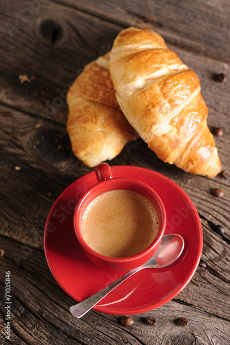 Croissants and coffee on wooden table