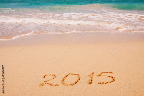 2015 written on sandy beach silvester. 