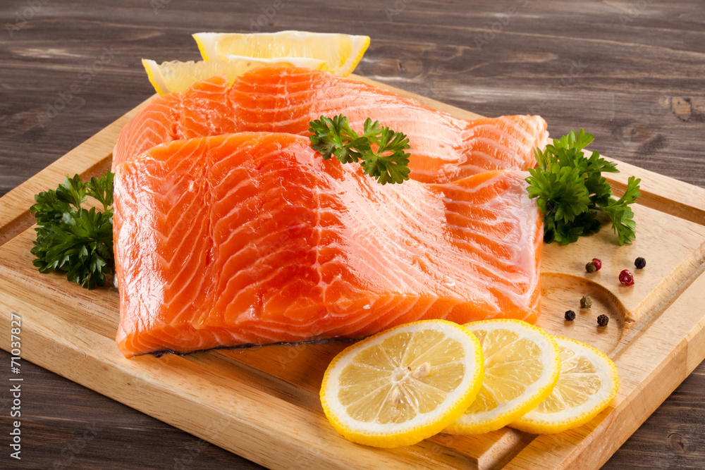 Fresh raw salmon fillet on cutting board Fresh raw salmon fillet on cutting board