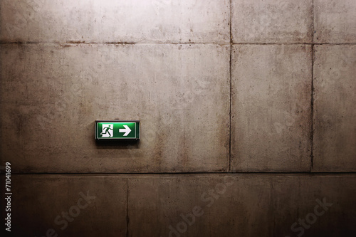 green exit sign on the wall photo