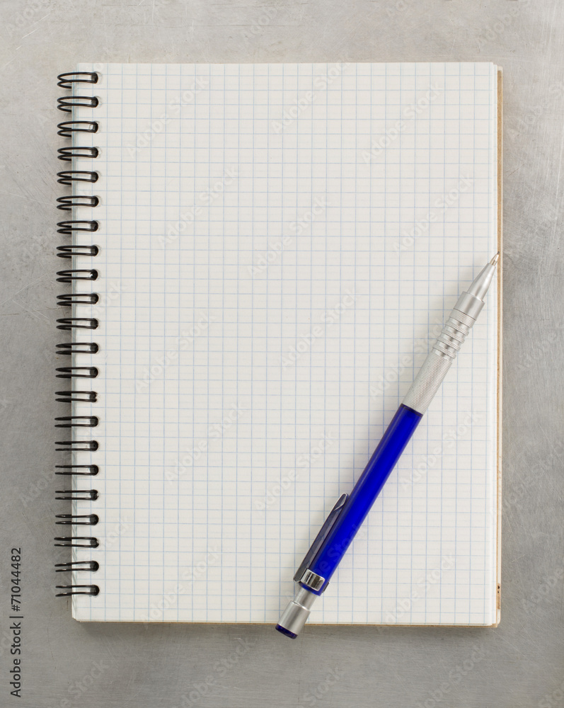 checked notebook at metal background checked notebook at metal background