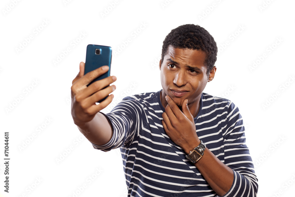 dark-skinned young man making selfie on white background