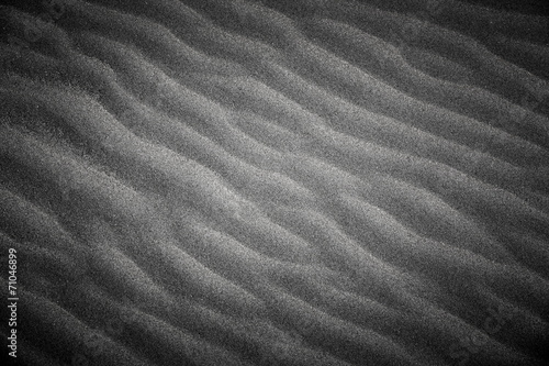 Wavy beach sand texture. Black and white with vignette.