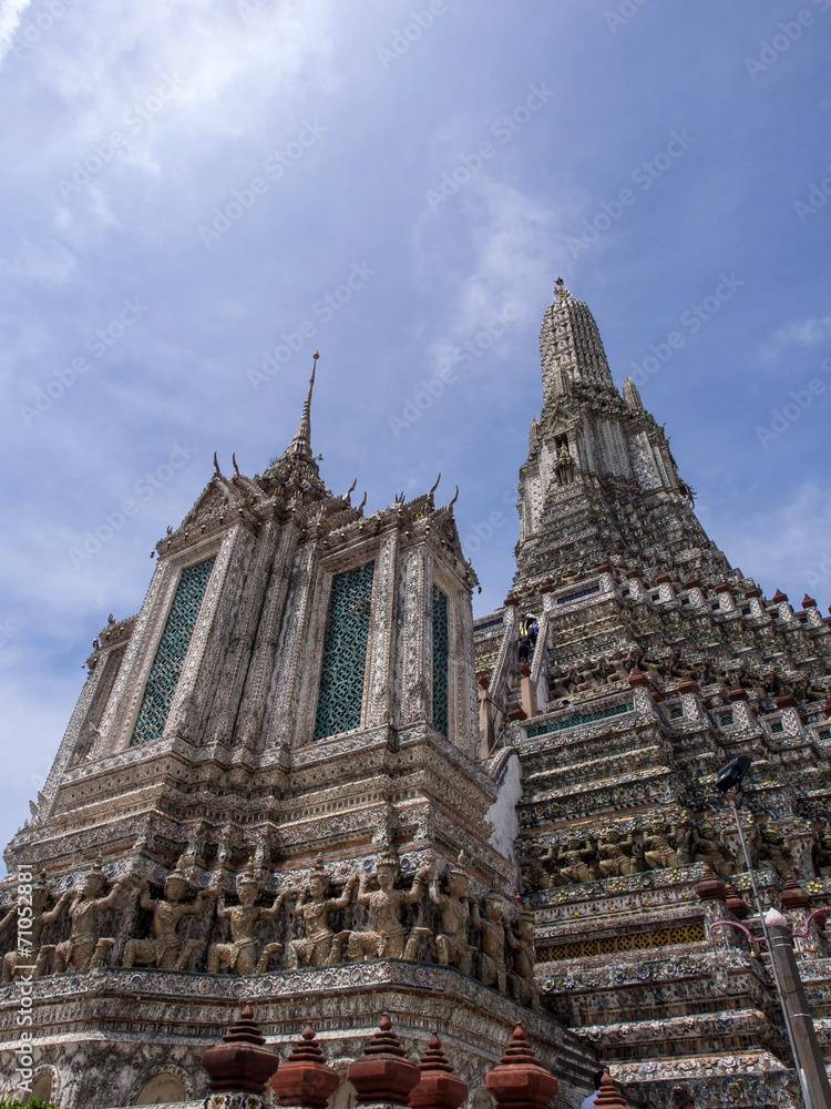 Dawn temple, landmark of Bangkok under cloudy blue sky