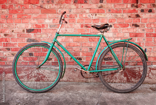 Old retro bicycle against brick wall