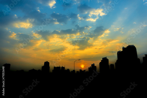 City silhouette with sunrise background