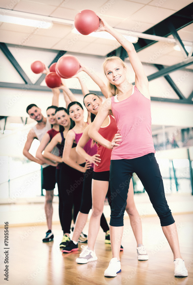 Fototapeta premium group of smiling people working out with ball