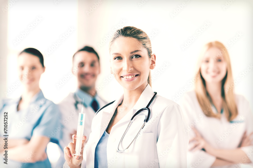 Fototapeta premium female doctor holding syringe with injection