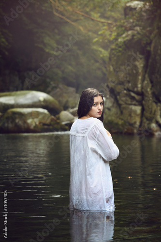 Beautiful woman posing in a mountain stream © captblack76