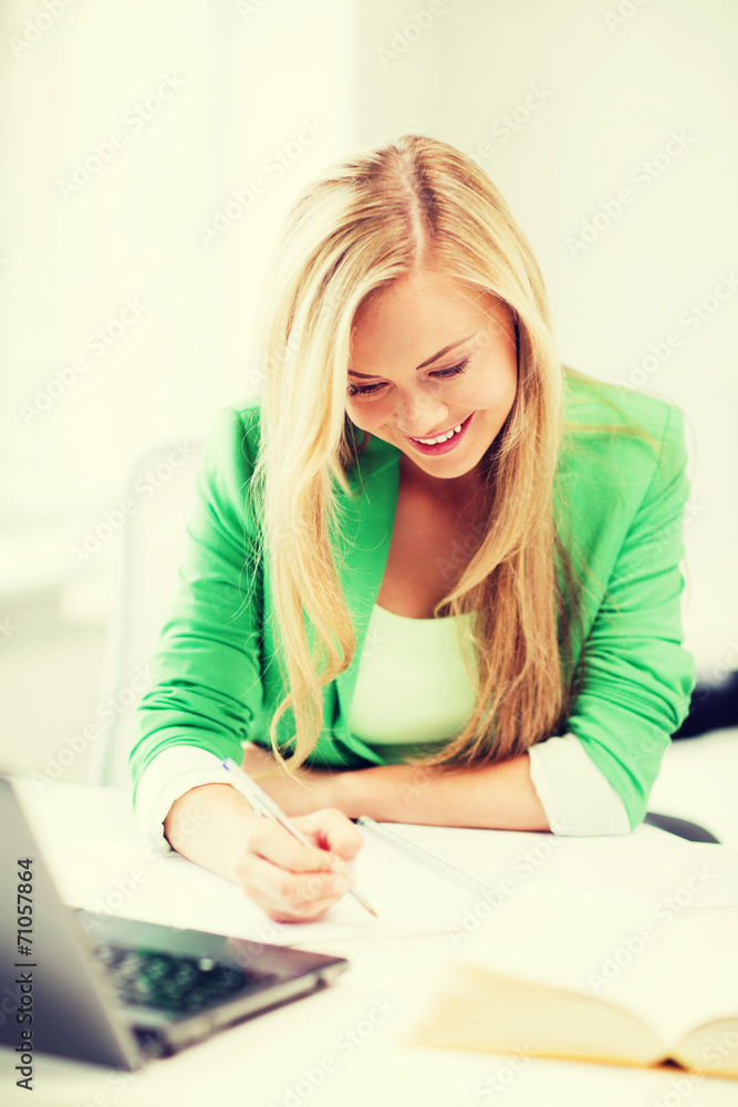 smiling student girl writing in notebook smiling student girl writing in notebook