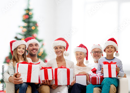 happy family in santa helper hats with gift boxes