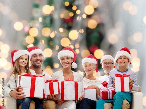 happy family in santa helper hats with gift boxes