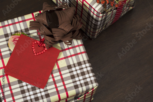 presents wrapped in checkered paper and brown ribbon with label