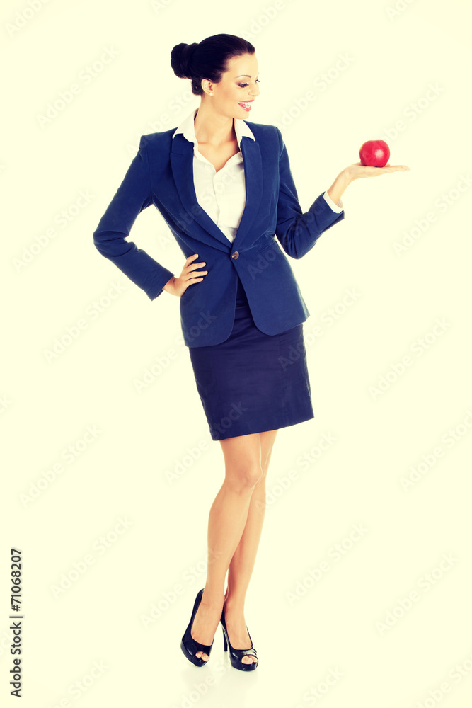 Attractive businesswoman holding red apple Attractive businesswoman holding red apple