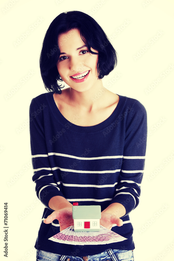 Happy woman holding euros bills and house model Happy woman holding euros bills and house model