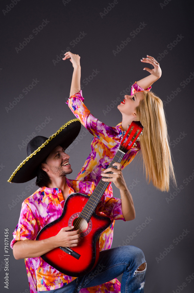 Fototapeta premium Spanish pair playing guitar and dancing