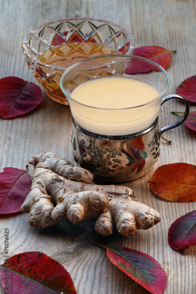 tea with ginger and honey, silver tea glass, red autumn leaves o