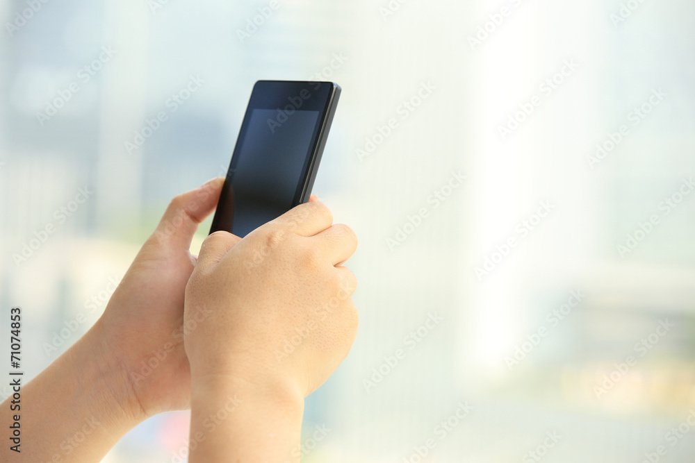 young woman hands use cellphone in city 