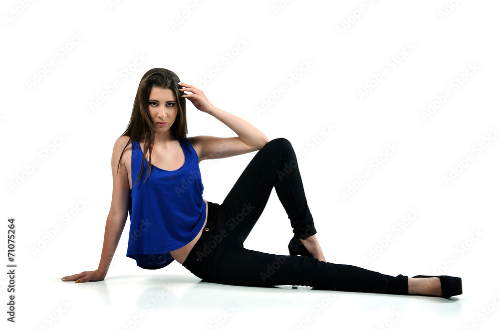 Young fashion model sitting on the studio floor Young fashion model sitting on the studio floor