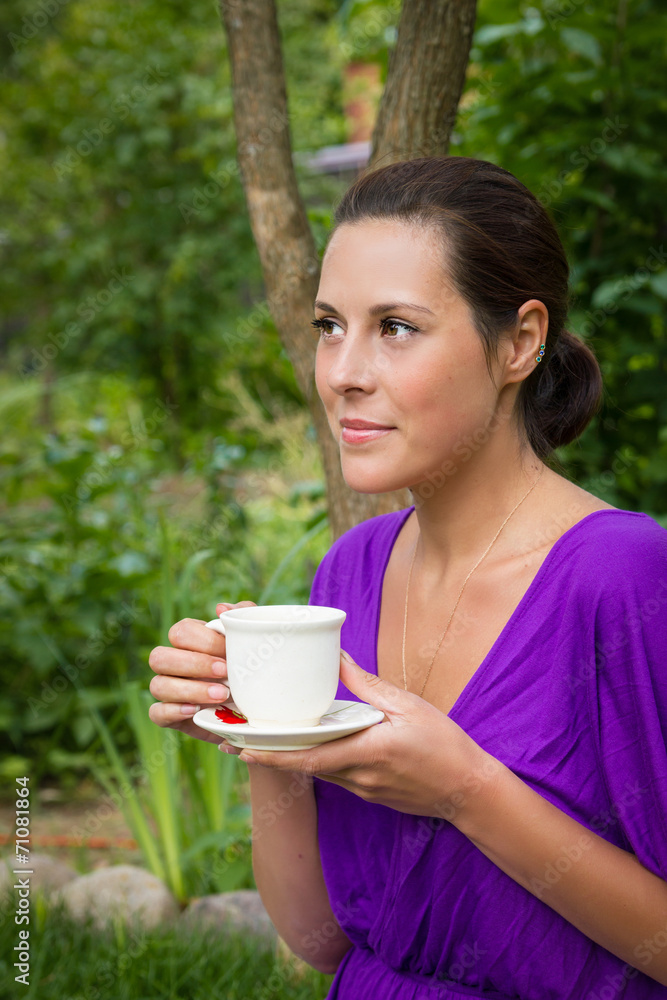 Beautiful young woman drinking coffee outdoors Beautiful young woman drinking coffee outdoors