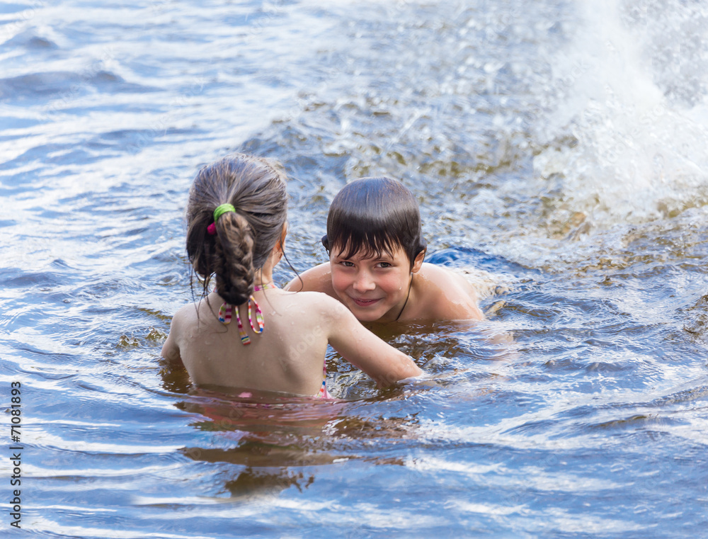 Little boy teaches his little sister to swim Little boy teaches his little sister to swim