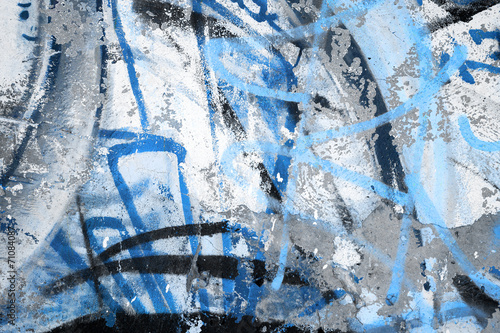 Abstract blue graffiti fragment on gray urban concrete wall
