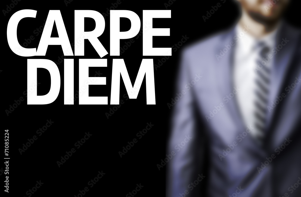 Carpe Diem written on a board with a business man on background Carpe Diem written on a board with a business man on background