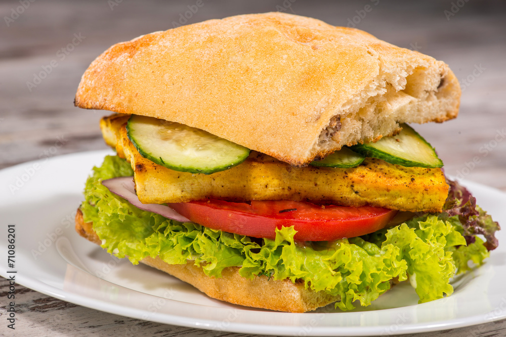 Close-up picture of vegetarian sandwich with tofu, tomatoes, sal Close-up picture of vegetarian sandwich with tofu, tomatoes, sal