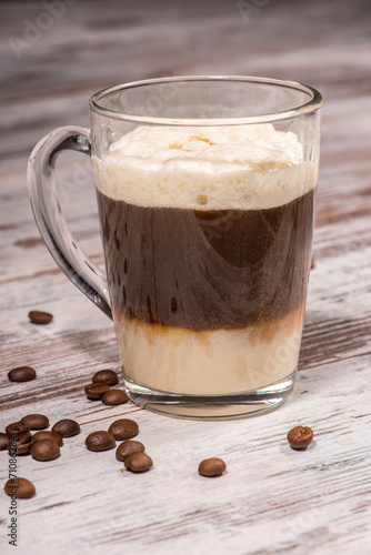 Close-up picture of tasty milk coffee dessert standing on the wo