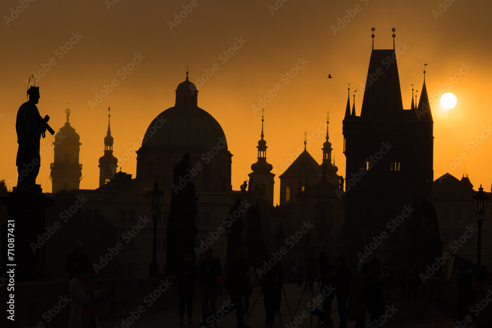 Silhouettes of Prague towers and statues on Charles bridge durin