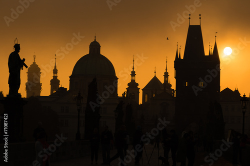 Silhouettes of Prague towers and statues on Charles bridge durin