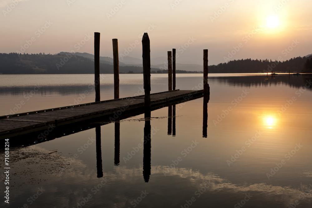 Tranquil warm sunrise over lake.
