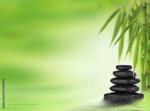 Spa background with stacked massage stones and bamboo
