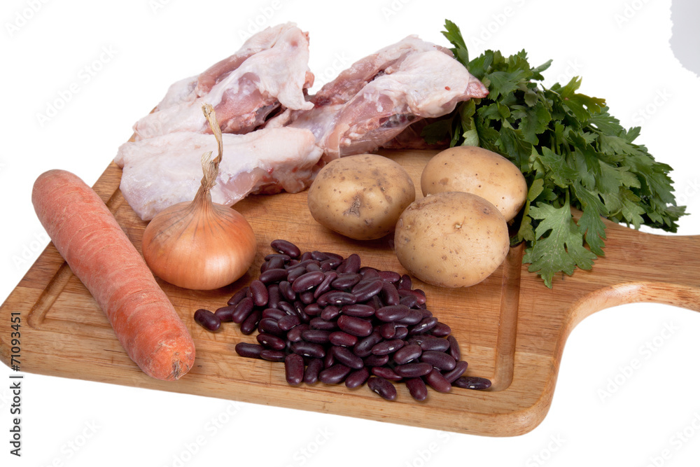 Vegetables, pork and beans on the board isolated on white backgr Vegetables, pork and beans on the board isolated on white backgr