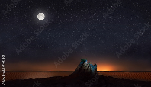 moon and stars over stone in desert #71093809
