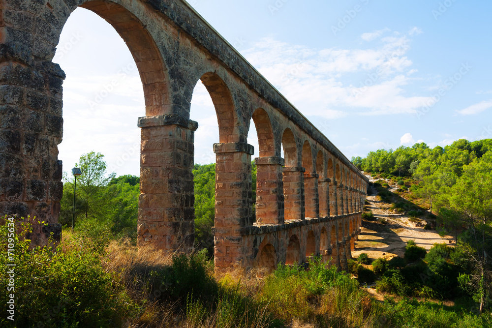 ancient  aqueduct in sunny day. Tarragona