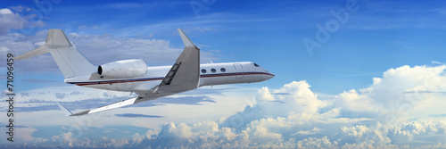 Corporate jet cruising in a cloudy sky